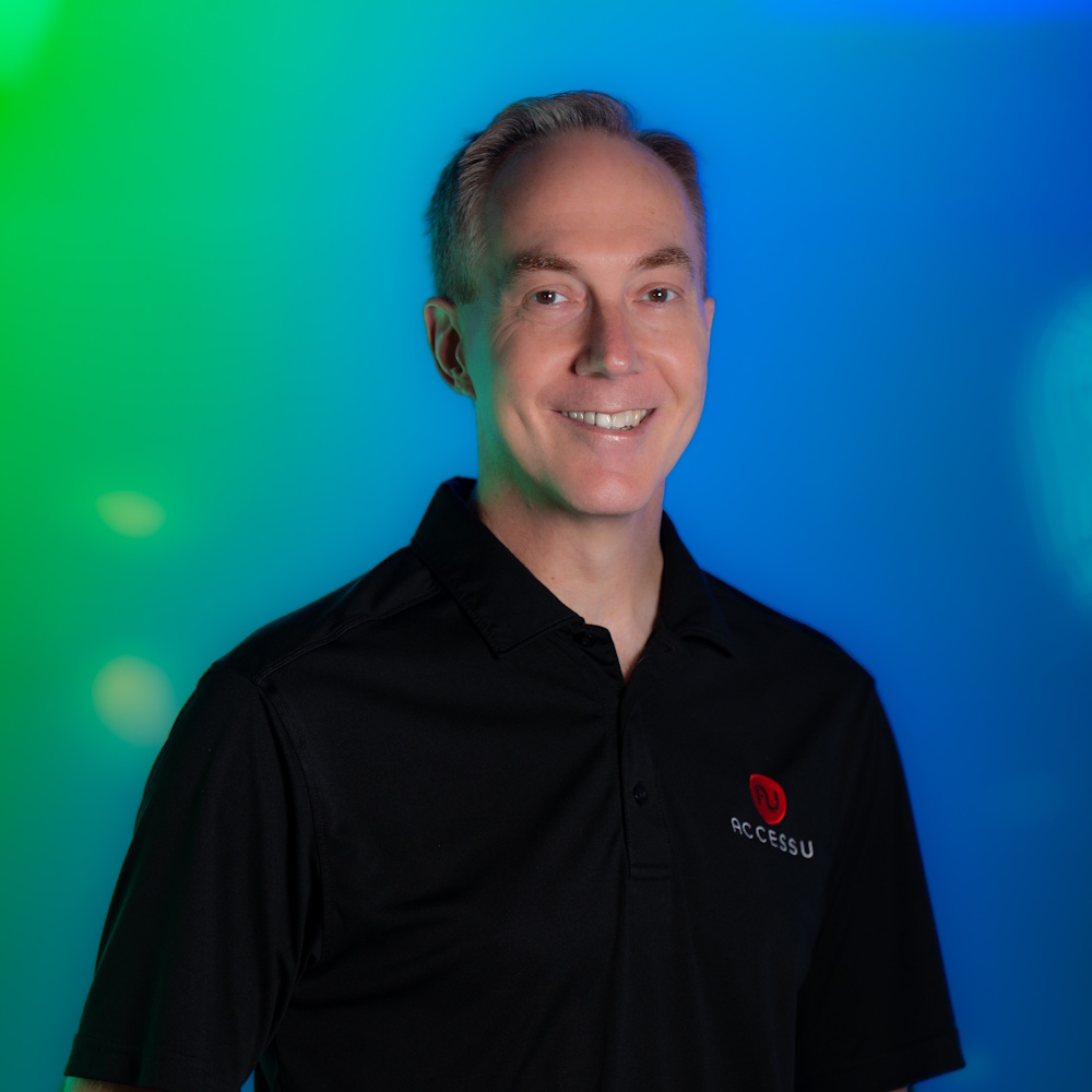 Greg Keene standing, smiling at camera