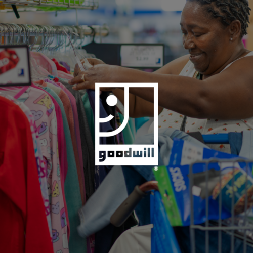 A woman browsing through clothing selections.