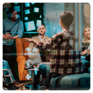 A group of people seated in a room talking.