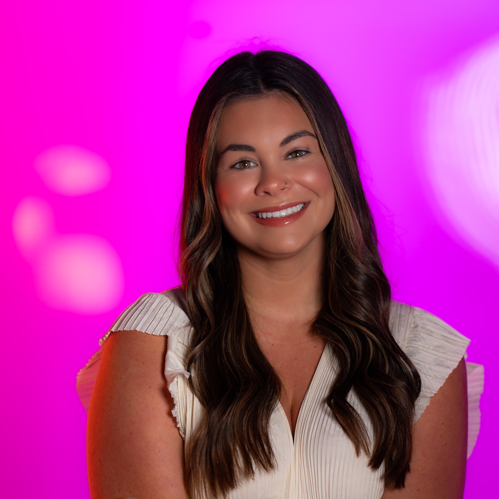 Olivia Boothe standing, smiling at camera