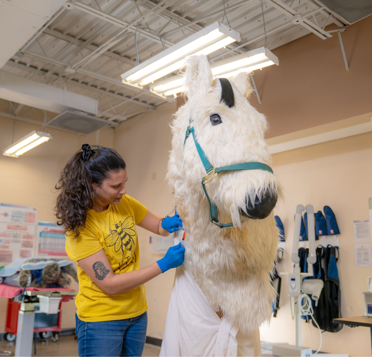 A woman working on a large stuffed horse