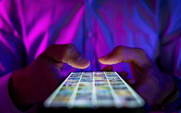 A closeup of hands tapping on a smartphone