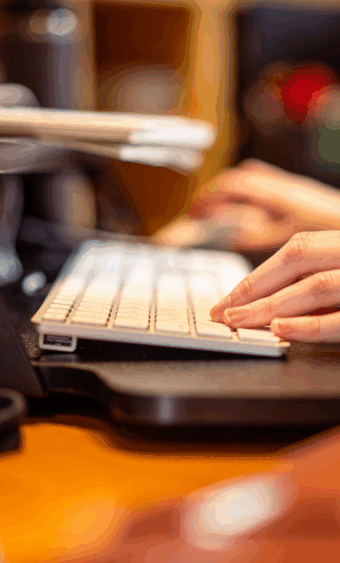 A closeup of hands typing on a keyboard