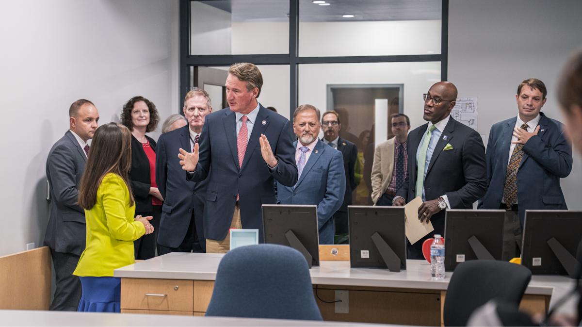 Governor Youngkin talking with a small group of people.