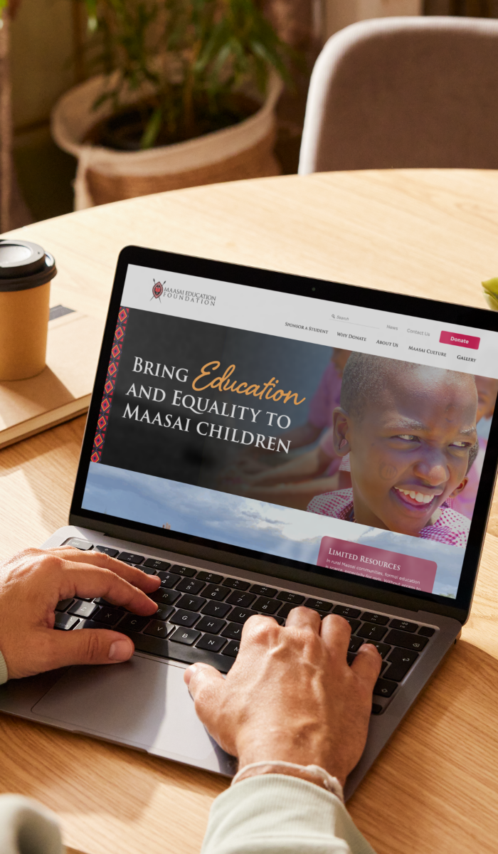 A laptop showing the Maasai Education Foundation website
