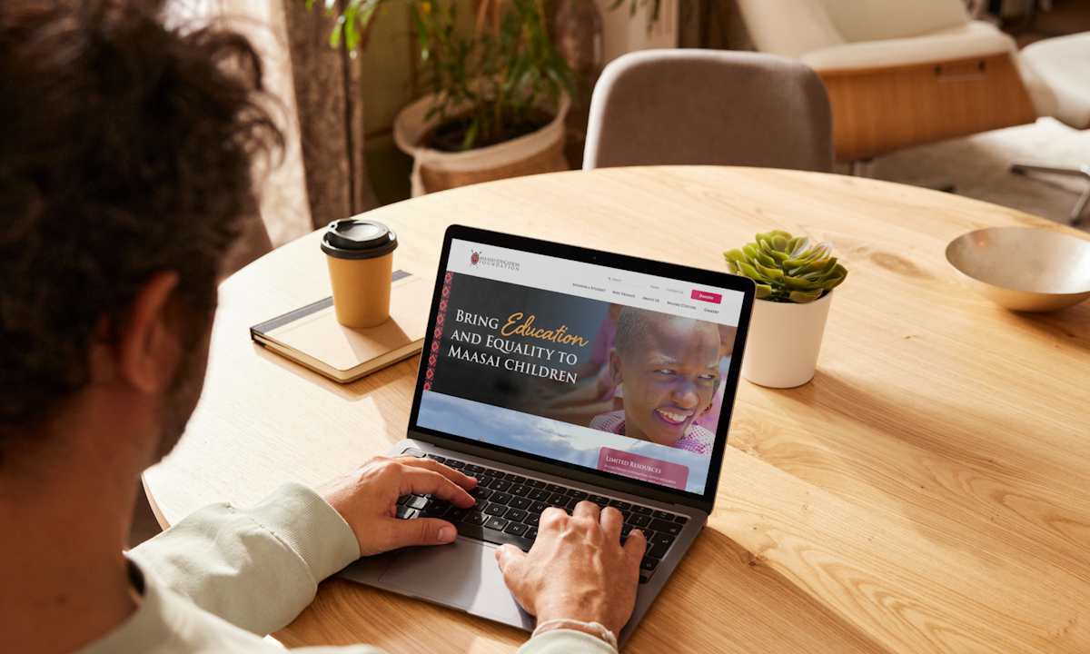 A laptop showing the Maasai Education Foundation website