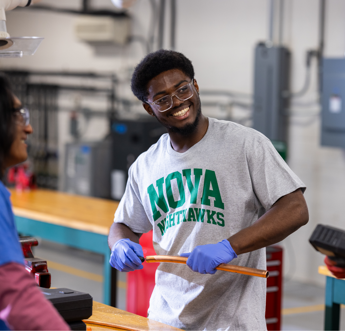 A man wearing safety glasses and a t-shirt.
