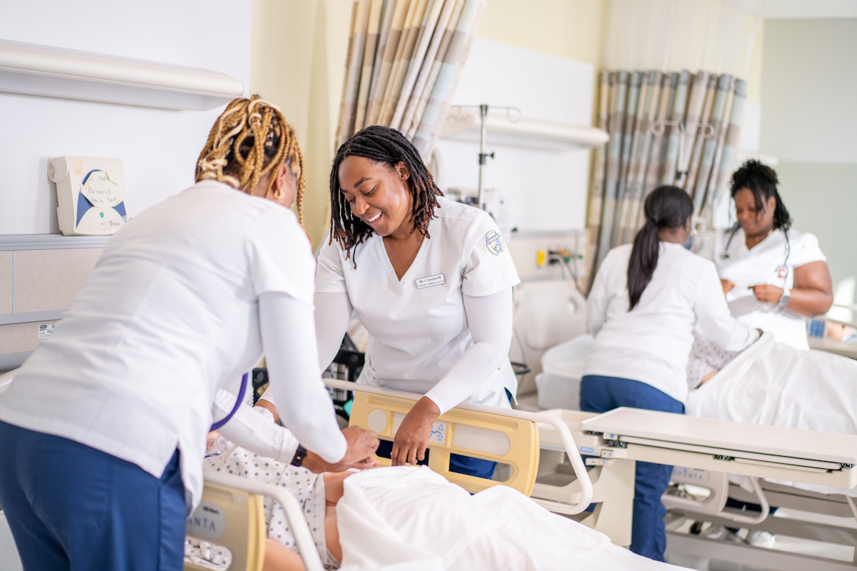 Nurses working in a room with patients.