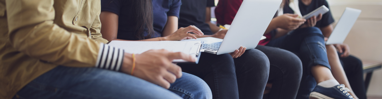 Closeup of people with laptops on their laps